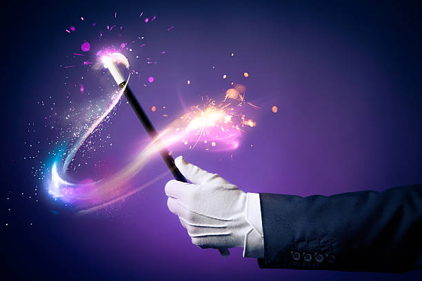 high-contrast-image-of-magician-hand-with-magic-wand-picture-id537273791